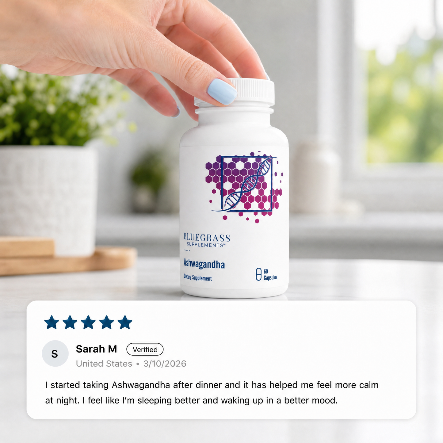 Hand holding a bottle of Bluegrass Ashwagandha supplement with a five-star rating from Sarah M.