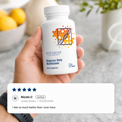 Hand holding a Bluegrass Daily Multivitamin bottle with a five-star review displayed.