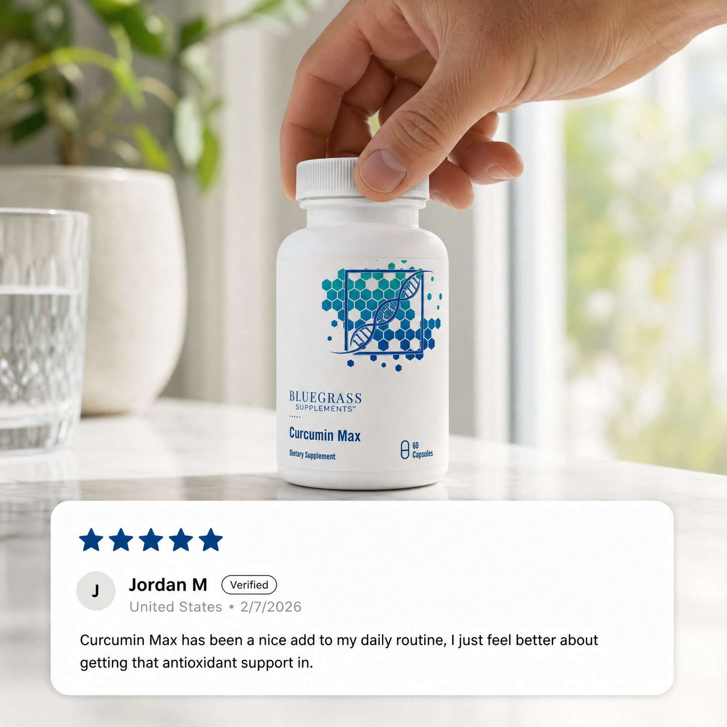Hand holding a bottle of Bluegrass Supplements Curcumin Max beside a customer review praising its antioxidant support