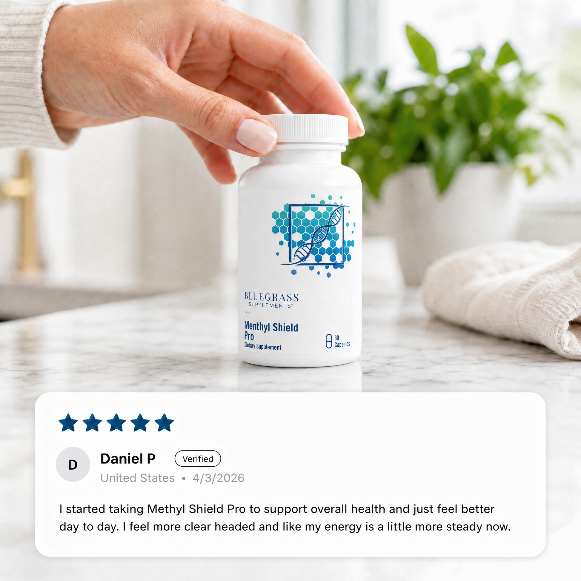 Hand holding a bottle labeled 'Bluegrass' with a product review displayed below on a neutral background.