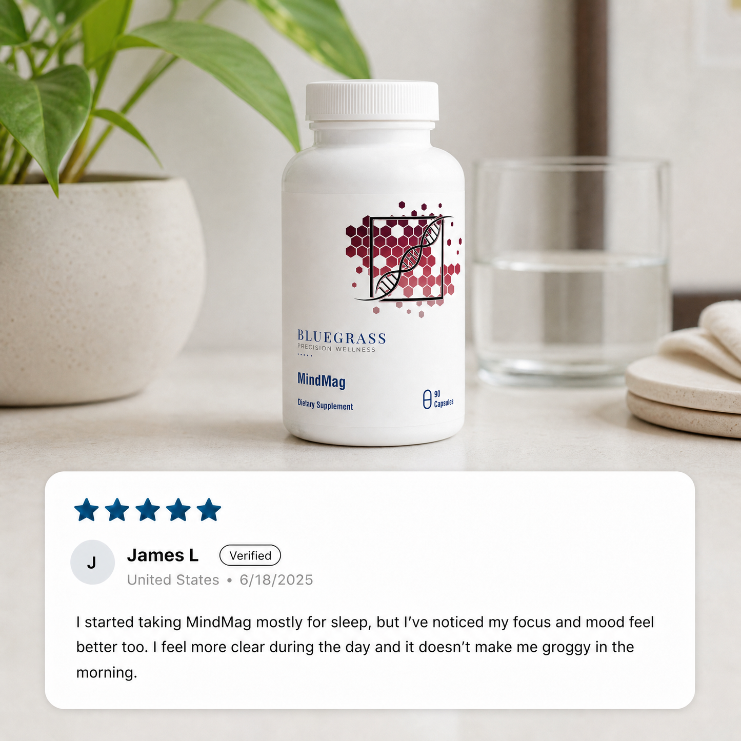 White supplement bottle with a brand logo on a surface with a plant and glass in the background.