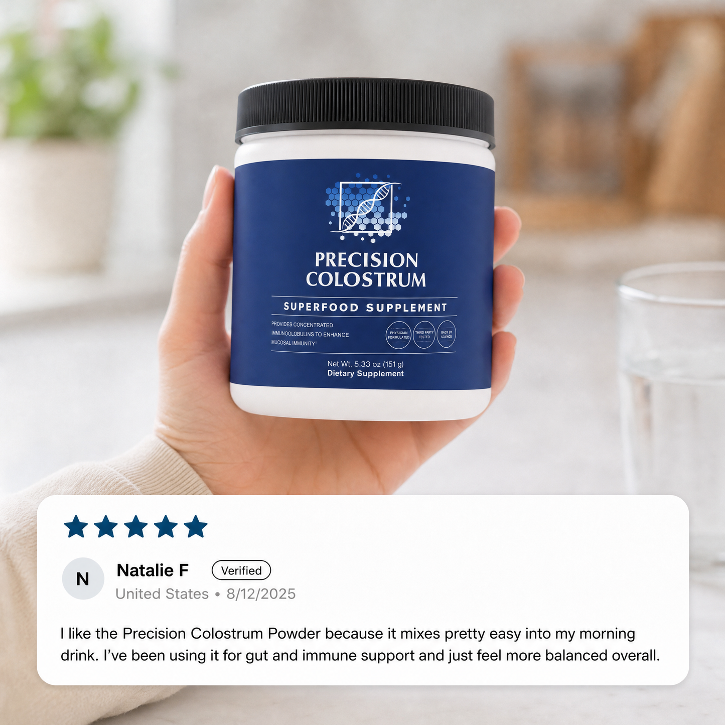 Hand holding a Precision Colostrum supplement container with a customer review displayed below.