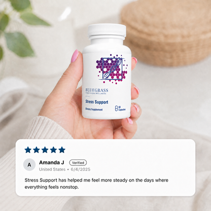 Supplement bottle with Bluegrass supplement label being held in someones hand with a blurred background.