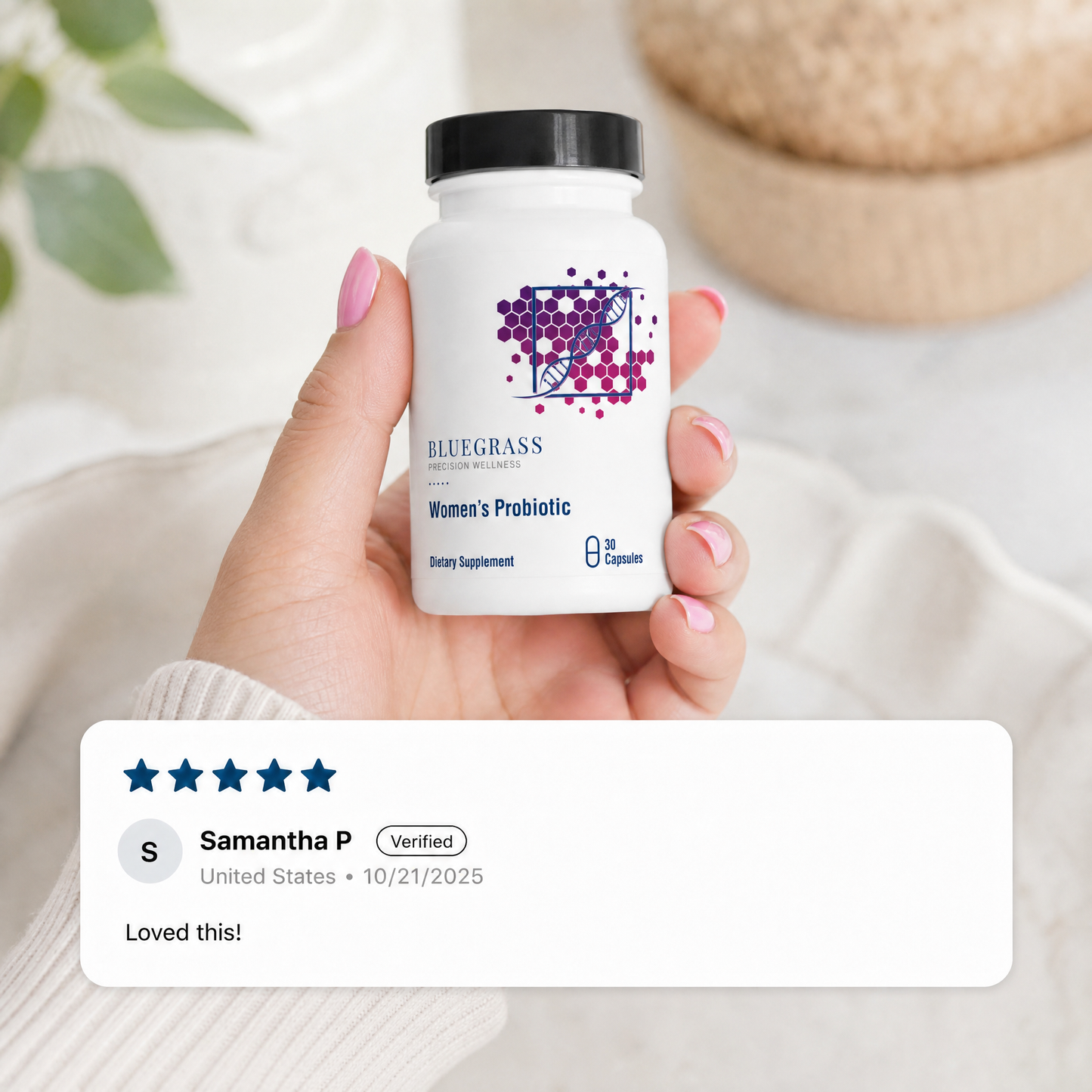 Hand holding a bottle of Bluegrass Women's Probiotic with a 5-star review from Samantha P.