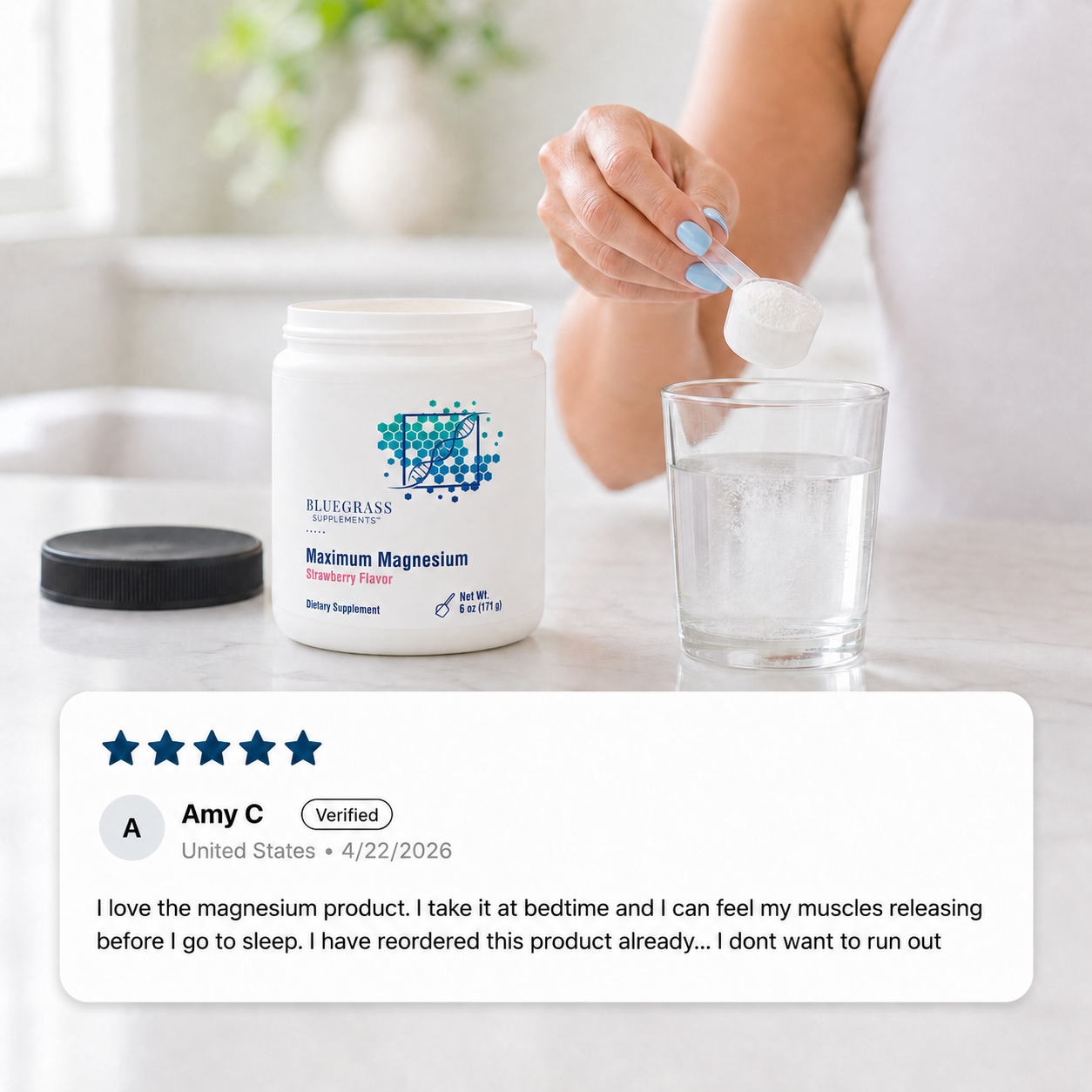 Person holding a supplement container labeled 'Bluegrass Supplements Maximum Magnesium' with a glass of water on a marble surface.