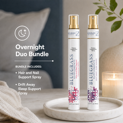 Two Bluegrass Supplements spray bottles on a marble tray with a cozy background.