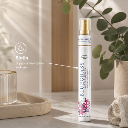 Bluegrass Hair and Nail Spray on a neutral background with decorative elements.