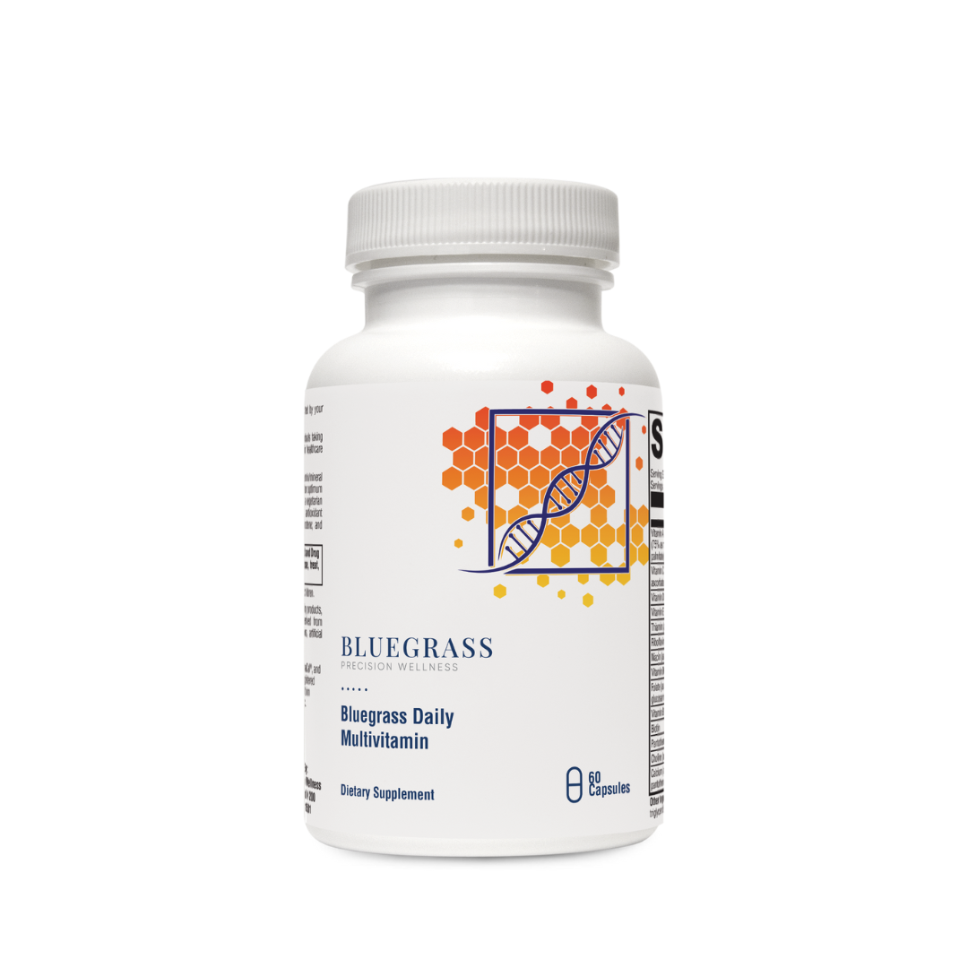 A bottle of Bluegrass Daily Multivitamin supplements with orange and green label design featuring vitamins and minerals.
