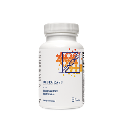 A bottle of Bluegrass Daily Multivitamin supplements with orange and green label design featuring vitamins and minerals.