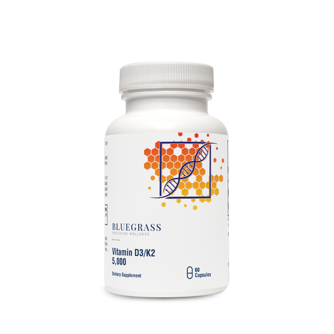 A bottle of Bluegrass Vitamin D3/K2 5000 supplements with a label featuring a DNA double helix.